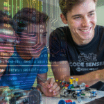 a code ninjas sensei showing kids how to code by pointing at a laptop